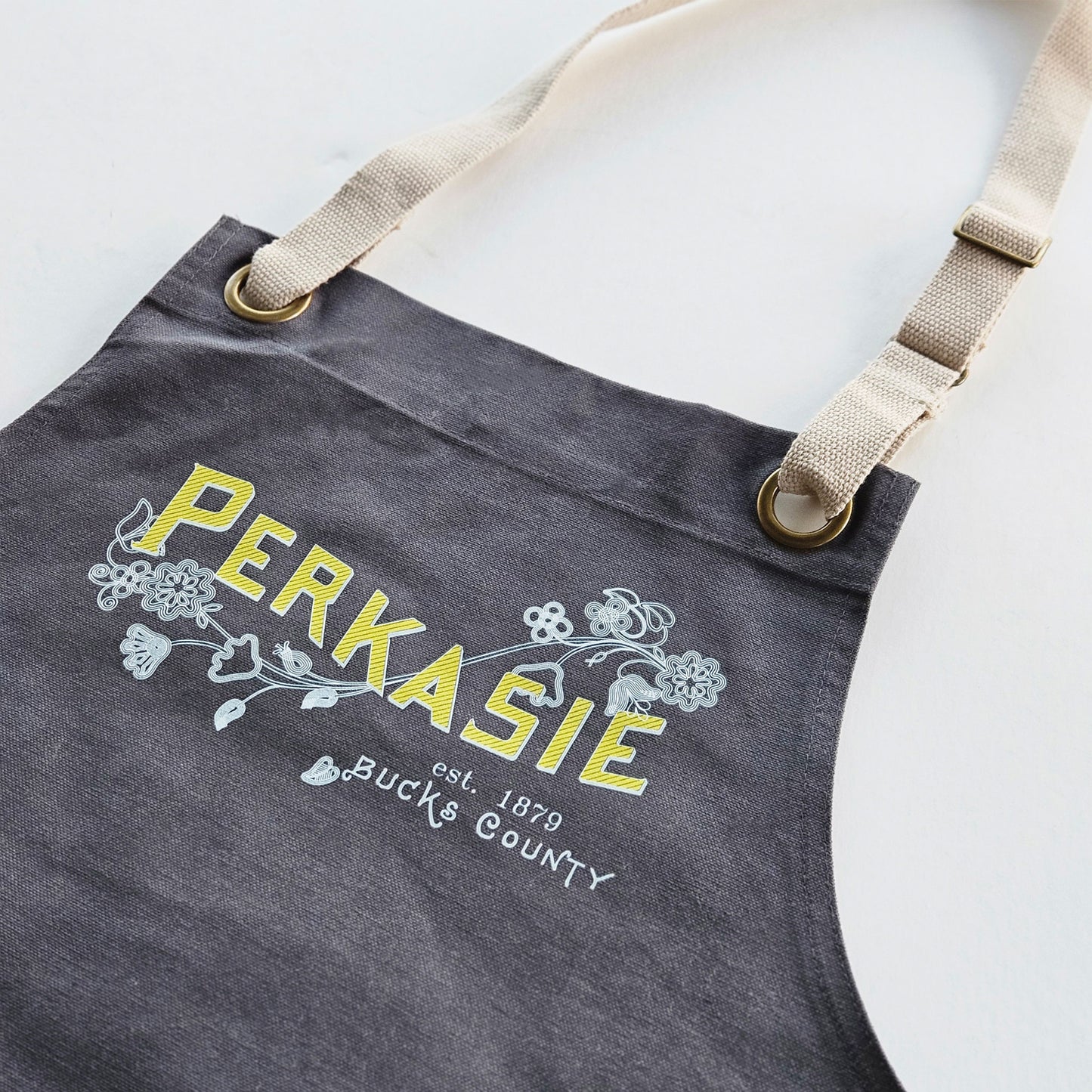 Perkasie Lenape floral motif graphic Apron - in grey or navy